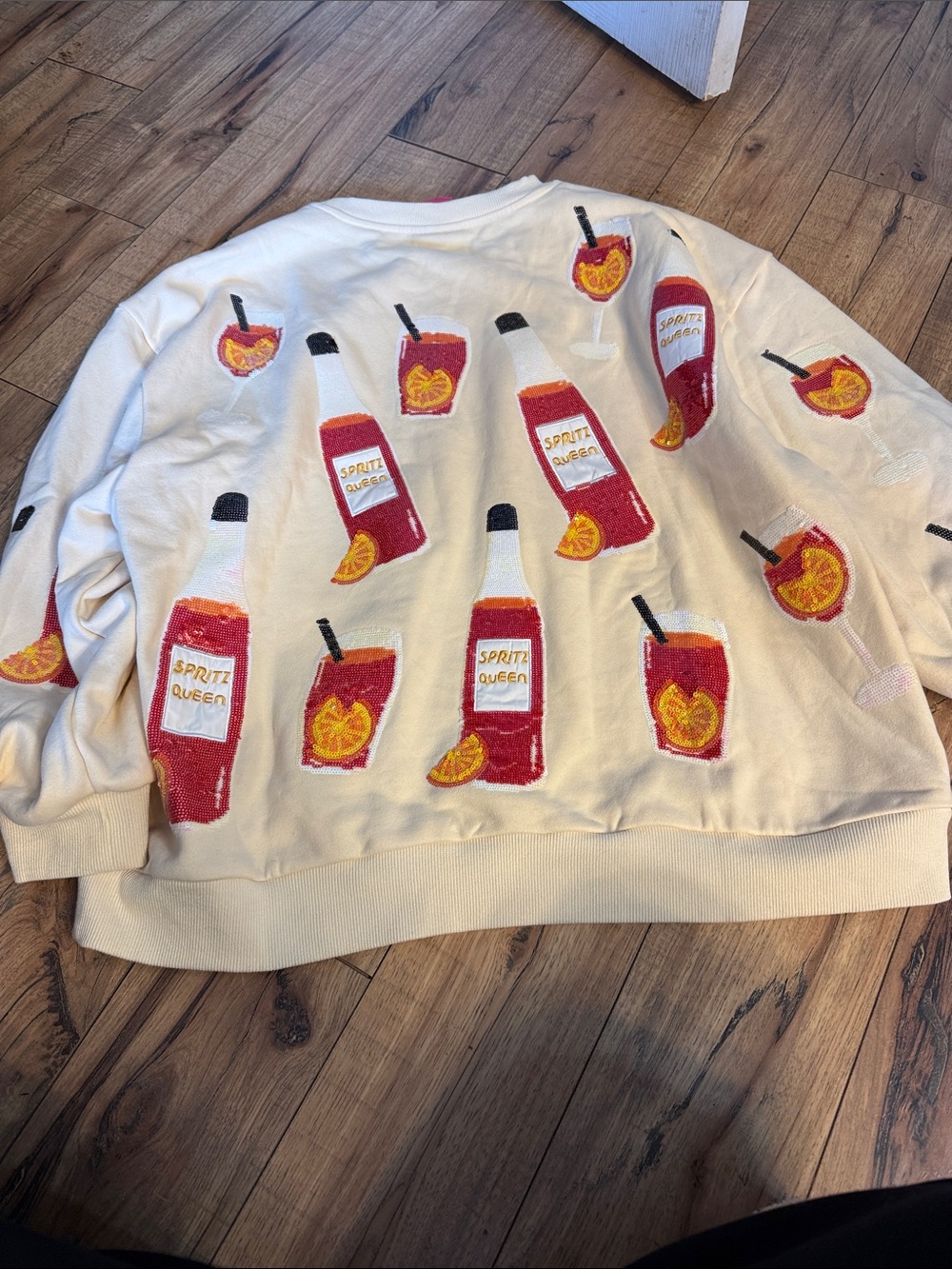 QUEEN OF SPARKLES Cream Sweater with Red & Orange Spritz Bottle Motif - Picture 4 of 4
